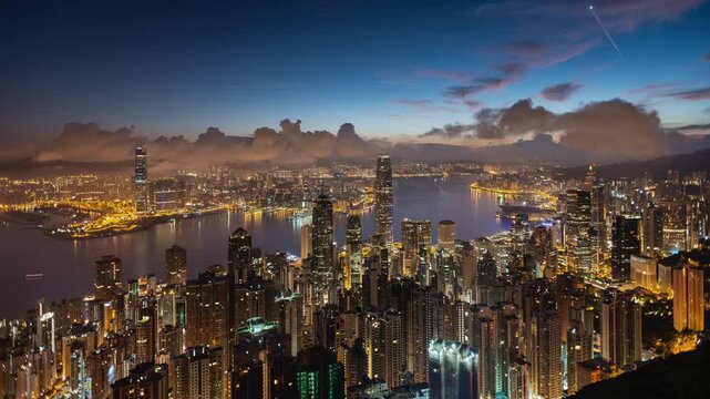 Asia, China,  Hong Kong, night to day transition time lapse of hong kong island financial district and Victoria bay, with high rise apartment blocks in foreground