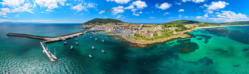 Fototapeta premium Ultrawide panoramic View of Fisterra Coastal Village and Harbor Adjacent to Langosteira Beach in Galicia, Spain
