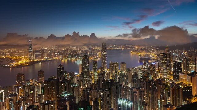 Asia, China,  Hong Kong, night to day transition zoom in time lapse of hong kong island financial district and Victoria bay, with high rise apartment blocks in foreground