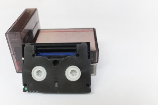 old film camera, Close-up of stacked video cassettes, isolated on white background