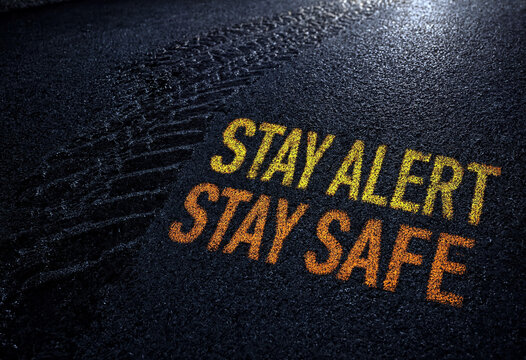 Inspirational stay alert stay safe message written on a dark textured surface for awareness