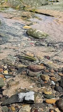 Static camera shot. Max 150 characters
Gentle ripples shimmer across a coastal rock pool, capturing tranquil seawater, natural textures and peaceful seaside scenery in close-up. Vertical static shot