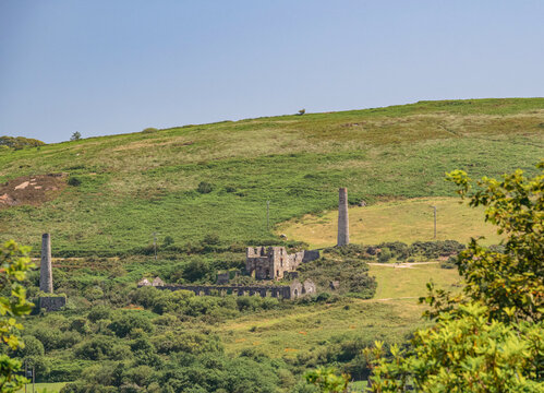 The ruins of tin mine workings and tall chimneys.