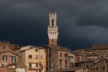 Obraz premium The iconic Torre del Mangia, which towers over the Palazzo Pubblico in the Piazza del Campo in Siena, Italy, Nightview