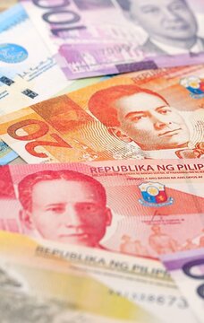 Philippines peso money bills pile on table. Philippines banknotes of PHP currency close up.