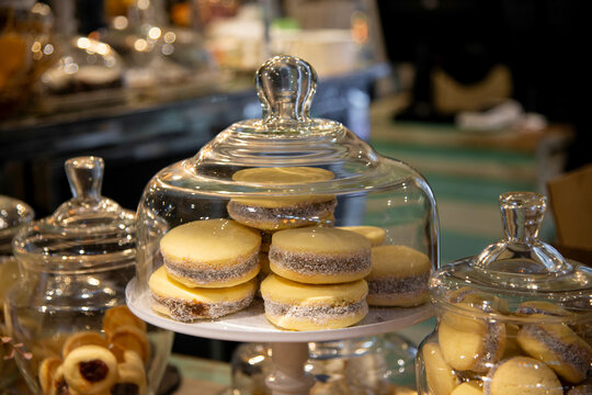 Traditional cornstarch alfajores with dulce de leche in glass dome