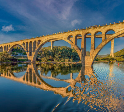 Navigating under the iconic bridges crossing the Douro river at Peso da Regua, Vila Real, Portugal