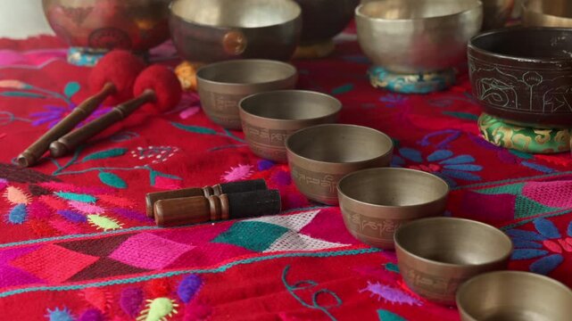 Tibetan singing bowls arranged, sound healing therapy, meditation instruments, vibrational wellness, acoustic therapy and spiritual healing.