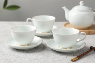 Fototapeta premium Elegant White Tea Set on Gray Background