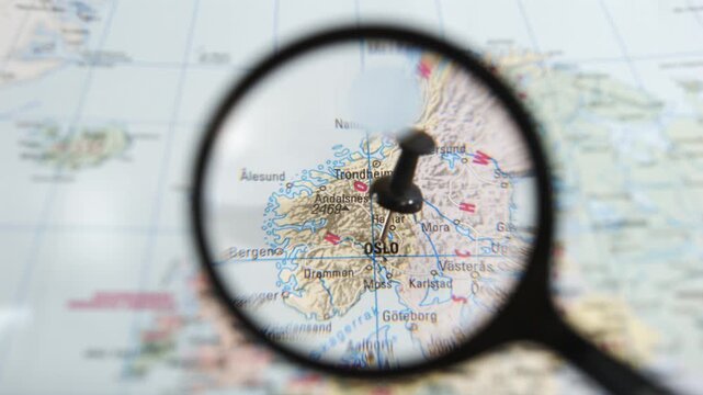 Exploring a map of Oslo with a magnifying glass