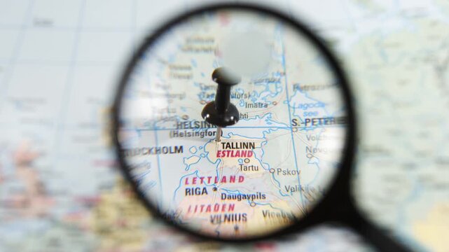 Exploring Tallinn, Estonia with a magnifying glass on a map