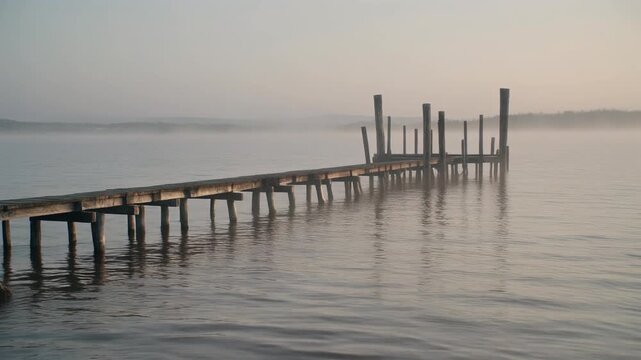 Cinematic footage of a flooded wooden dock at sunrise, ideal for travel editorial, tourism awareness, and coastal heritage storytelling content.