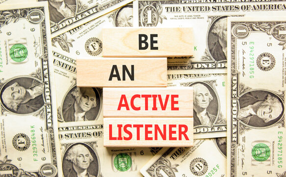 Be an active listener words symbol. Concept words Be an active listener on beautiful wooden blocks. Beautiful dollar bills background. Dollar bills. Business be an active listener concept. Copy space.