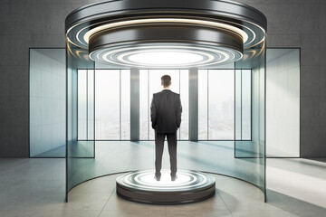 Naklejka premium Businessman standing on illuminated round platform inside futuristic glass teleportation capsule in modern interior with panoramic city view window.
