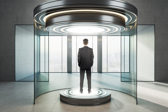 Businessman standing on illuminated round platform inside futuristic glass teleportation capsule in modern interior with panoramic city view window.