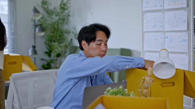 Asian businessman packing into cardboard box due to job layoff,worker replaced by AI automation,career retirement,ai disruption and modern technology,Digital Disruption,Document Management Data System
