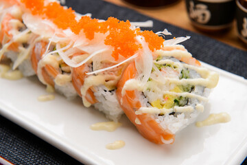 Fresh salmon sushi roll with sauce on white plate © Donghyun Kim