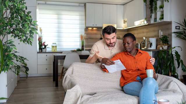 Couple discussing important matters in their home living room during the day