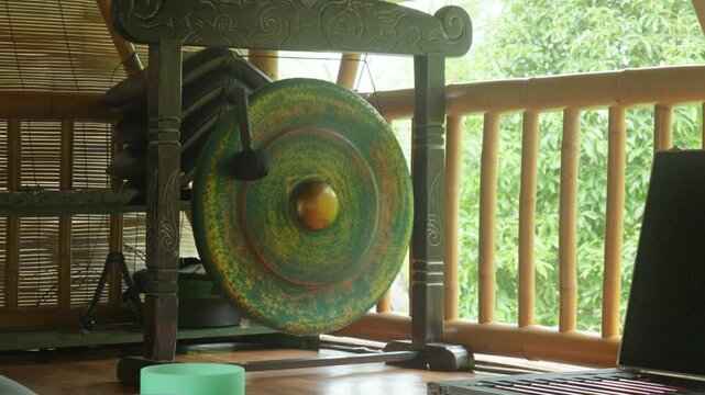 Gong standing on the floor before the start of the gong ceremony in a gazebo