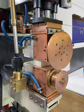 Close-up of spot welding machine with disc contacts for continuous metal sheets welding.