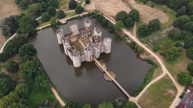 Aerial view of Bodiam Castle surrounded by a moat in England on a cloudy summer day