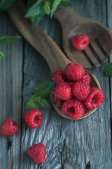 raspberries on wooden background and mints  © Lili