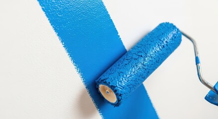 Obraz premium Applying fresh blue paint to an interior wall surface using a paint roller, suggesting home renovation and decor improvement, maintenance, renovation, brush