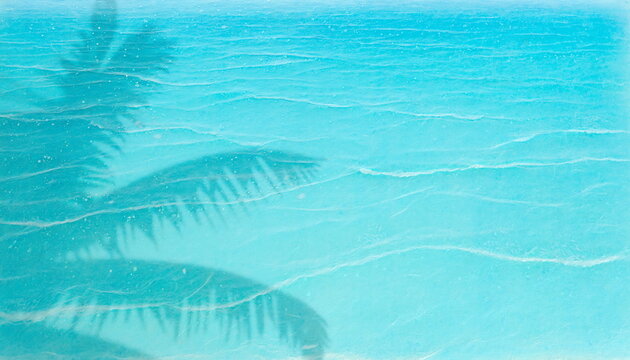 Palm tree shadow on turquoise tropical ocean ripples text space ターコイズブルーの熱帯の海面に映るヤシの木の影と穏やかな波紋