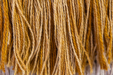 Fototapeta premium Close-up of bohemian style round wall decor with cotton fringe and texture