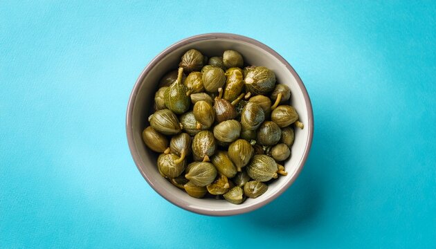 Capers In The Bowl On The Light Blue Background