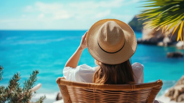 Woman Relaxing In Straw Chair Overlooking Turquoise Ocean During Sunny Vacation Escape