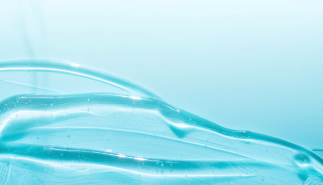 Clear turquoise gel cosmetic texture sample close up smooth background 滑らかに伸びる透明なターコイズブルーのジェル化粧品のテクスチャ背景