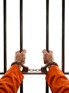 Prisoner gripping jail cell bars while wearing handcuffs isolated on white background. For legal consequences, detention, correctional facilities, and prison system