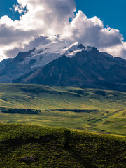 Fototapeta premium deAerial view of Genie Holy Mountain main peak, snow glacier mountain with alpine meadow and primitive forest, Hengduan Mountains natural scenery in Litang West Sichuanfault