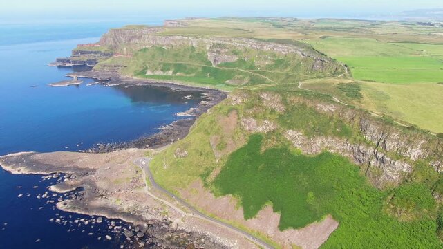 Spectacular aerial view of the iconic Giant's Causeway coastline in Northern Ireland. Drone Video of basalt columns, cliffs and Atlantic Ocean, and breathtaking coastal scenery