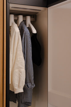 Clothes on Hangers in a Modern Wardrobe or Closet Interior