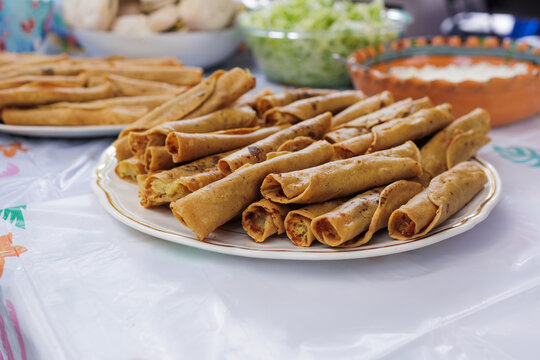 flautas de pollo or chicken fried tacos in Mexico Latin America, Mexican feast with Homemade food on table