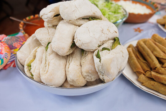 traditional mexican sandwich called chanclas in Mexico in a Mexican feast with Homemade food on table