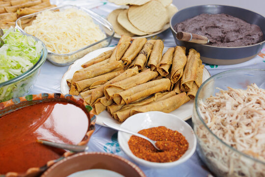 flautas de pollo or chicken fried tacos in Mexico Latin America, Mexican feast with Homemade food on table