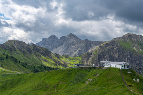 Ski lift valley station in little valley of Walser, mountain railway in spring on a blooming alpine meadow, many different alpine flowers form a colorful pasture for the cows
