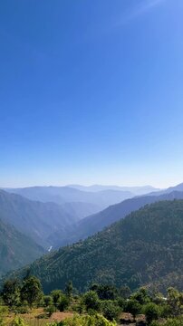 Aerial view of deep green mountain valleys layered peaks, raw wilderness nature. Atmospheric scenery, travel adventure tourism environment. Nepal, bhutan and meghalaya, vietnam outdoor vertical mobile
