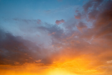 Fototapeta premium Dramatic Orange and Blue Sunset Sky with Clouds