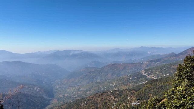 Panoramic view of majestic mountain peaks, hazy deep valleys. Bright sky, lush green forests, rural terraced villages. Nepal Mount everest global travel tourism nature adventure exciting trekking view