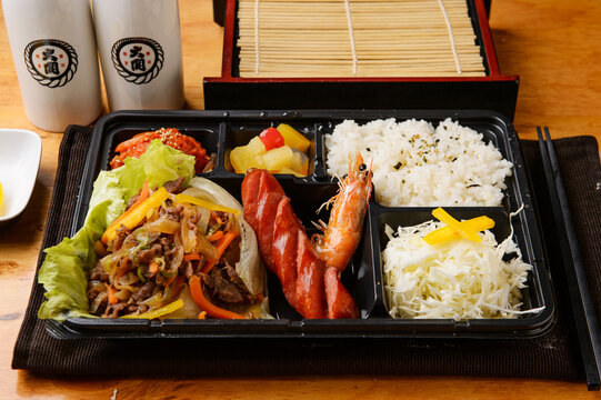Korean lunch box dosirak with rice sausage and side dishes