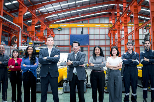 Business partnership in manufacturing. Executives and factory professionals celebrate a successful handshake inside an industrial plant. Partnership, teamwork, leadership, industry, success