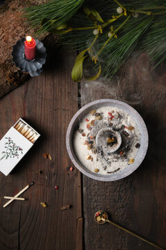 Top view of burning incense with smoke (frankincense, myrrh and herbs) in a censer