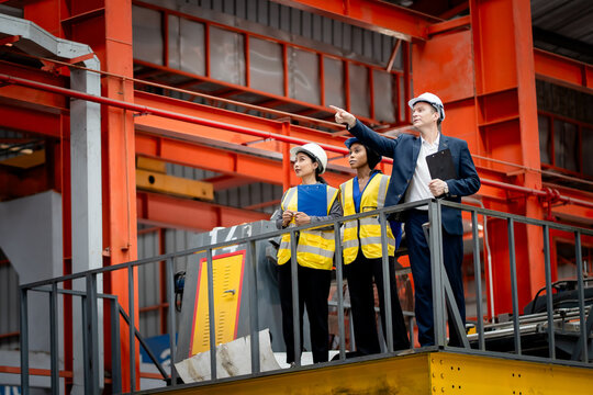Industrial leadership and factory inspection. Engineers and managers review production operations on a manufacturing platform. Leadership, inspection, industry, teamwork, manufacturing
