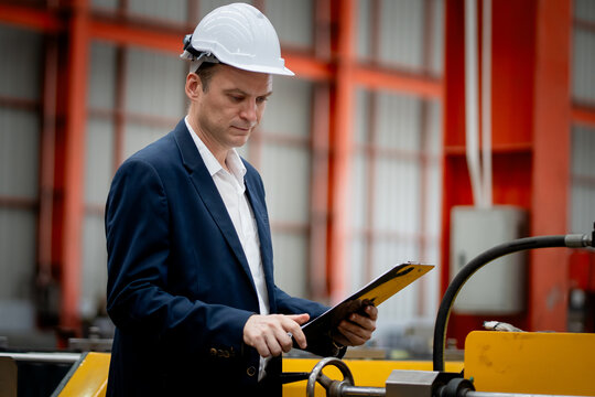 Caucasian professional Engineer factory. Engineering worker in safety hardhat at factory industrial facilities. Heavy Industry Manufacturing Factory