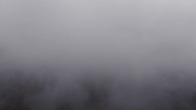 White cloud and fog reveals billowing crater on volcanic mountain - Ebino Plateau, Miyazaki, Japan