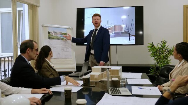 Professional architect showing a new real estate model to a group of colleagues in a boardroom